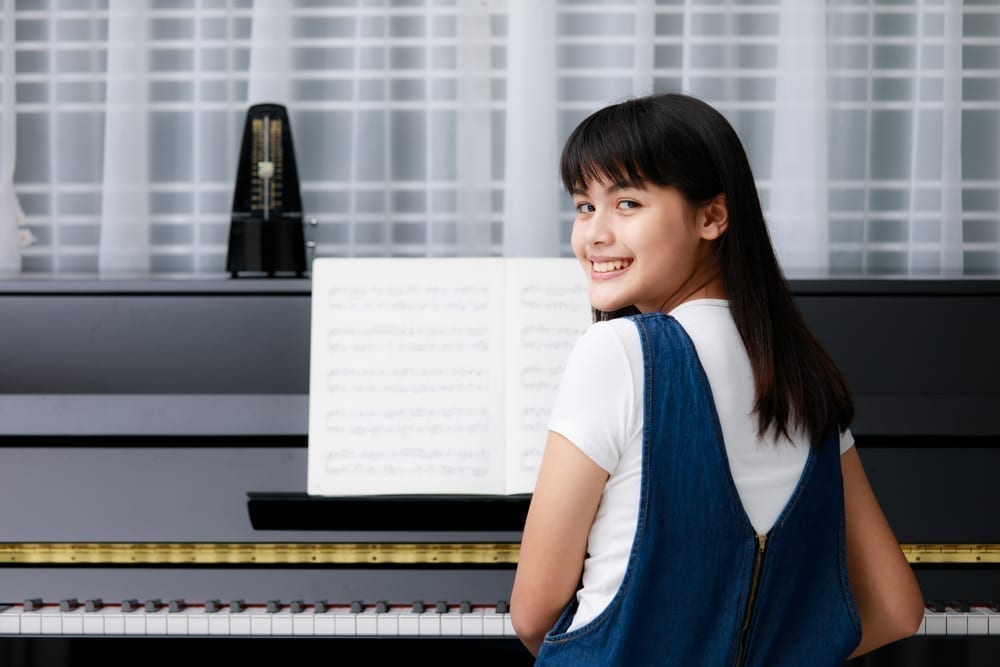 Young girl sitting at piano