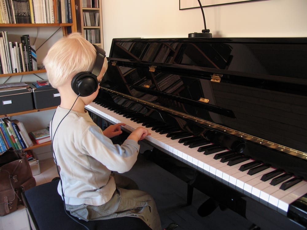 Boy playing the silent piano