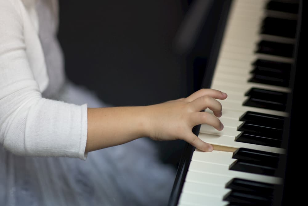 Piano lesson for beginner. Six-year-old girl started learning piano