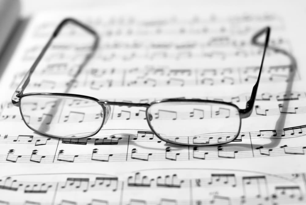 Sheet piano music and glasses for short-sightedness