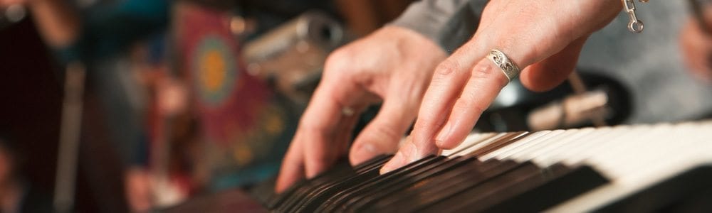 hands playing rock and roll style piano